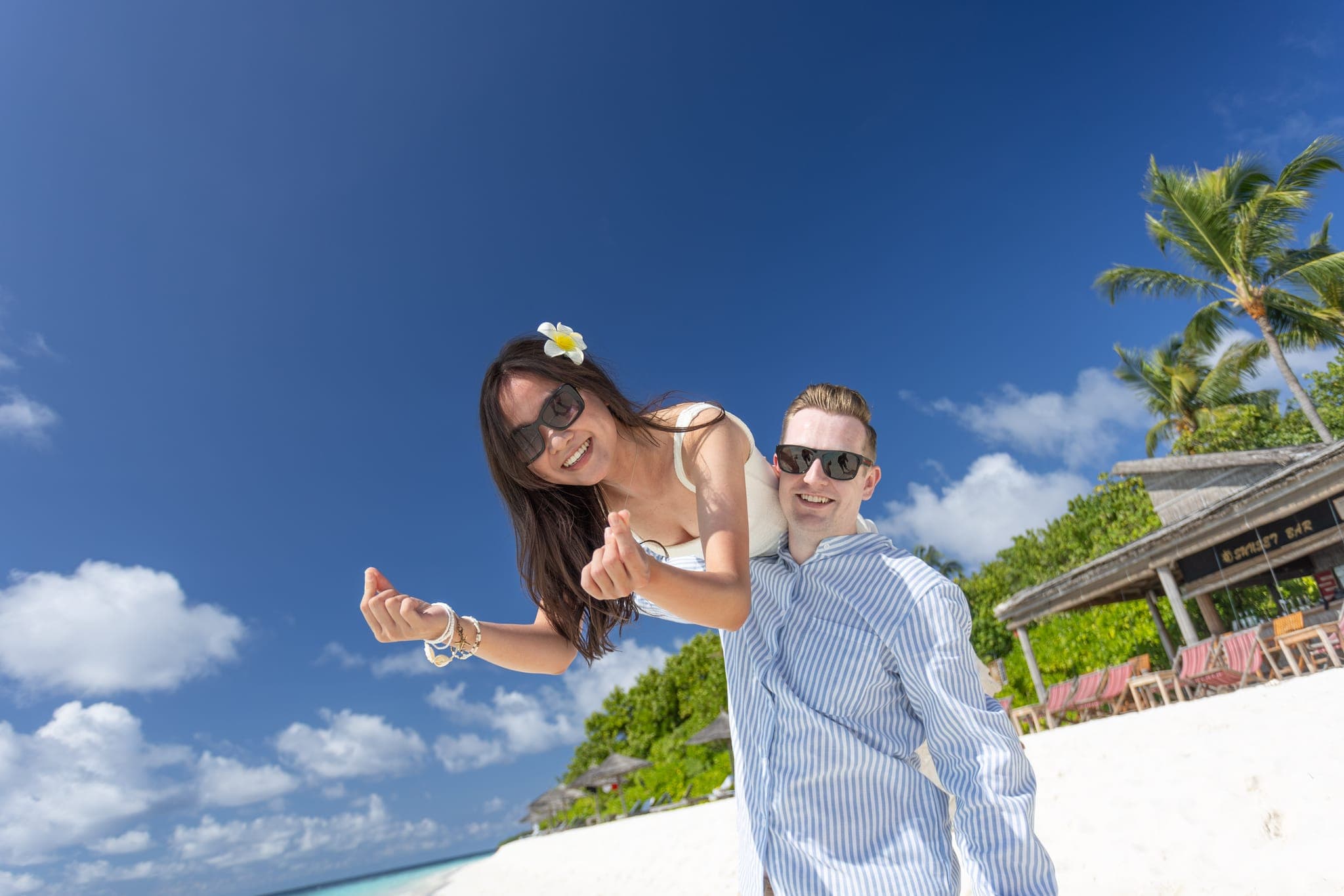 Couple laughing together on sunny tropical beach