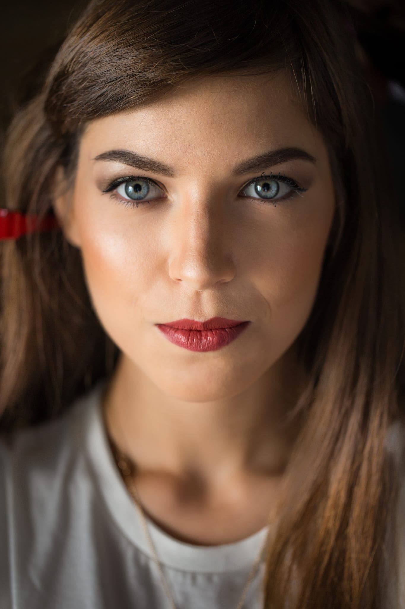 Close-up portrait of woman with red lipstick and blue eyes