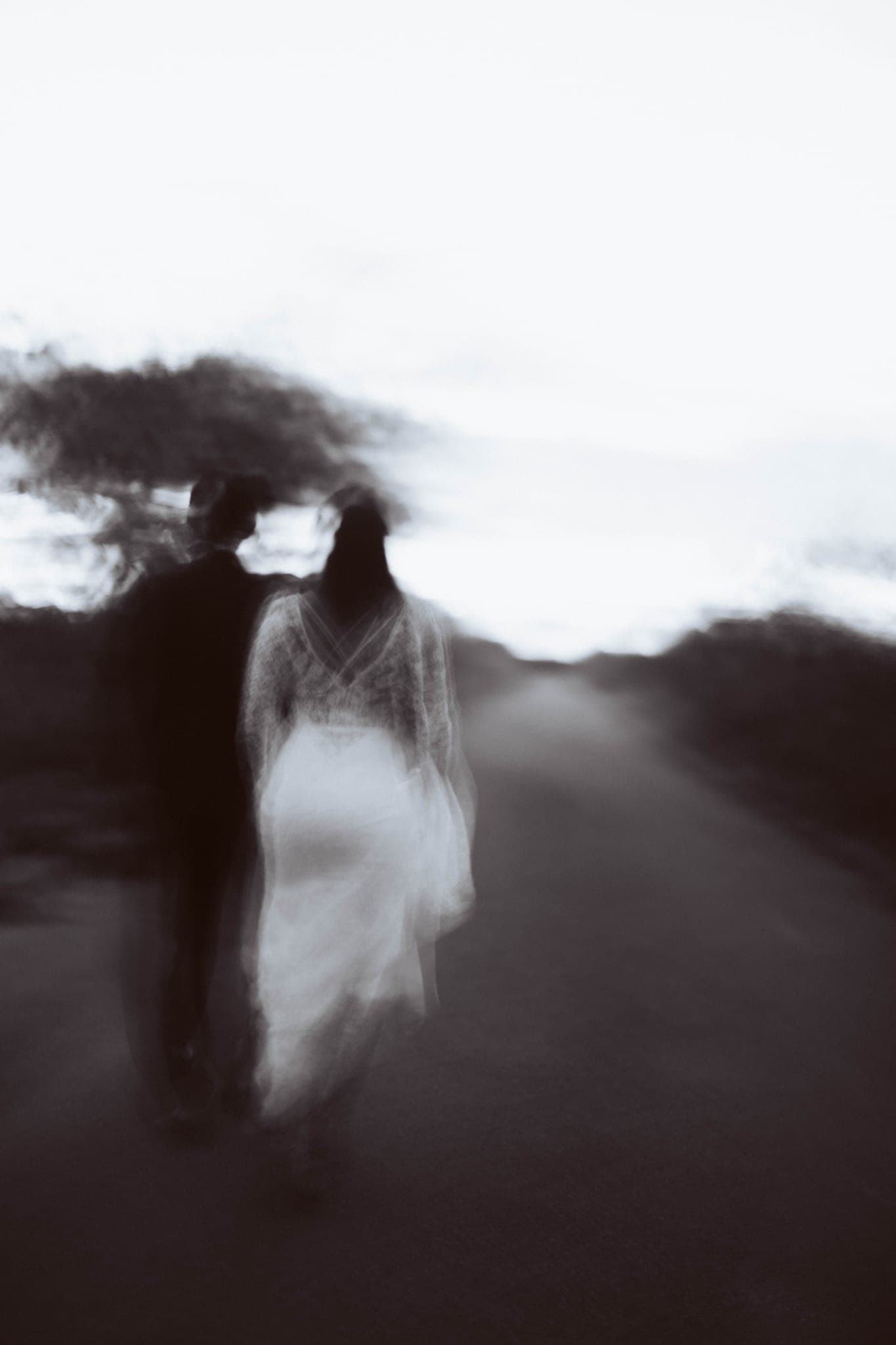 Blurred motion shot of couple walking down a road