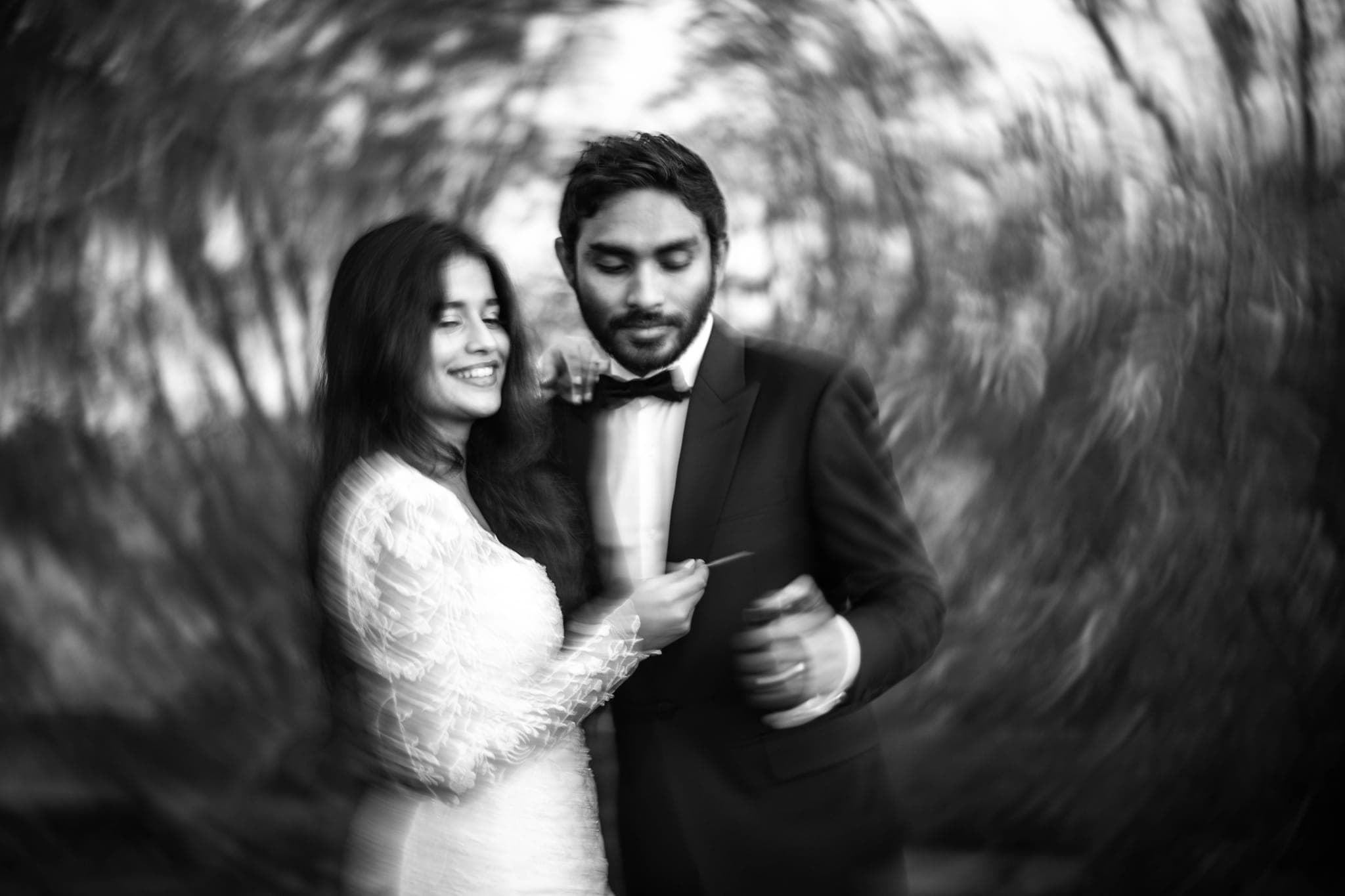 Swirled motion blur portrait of smiling bride and groom