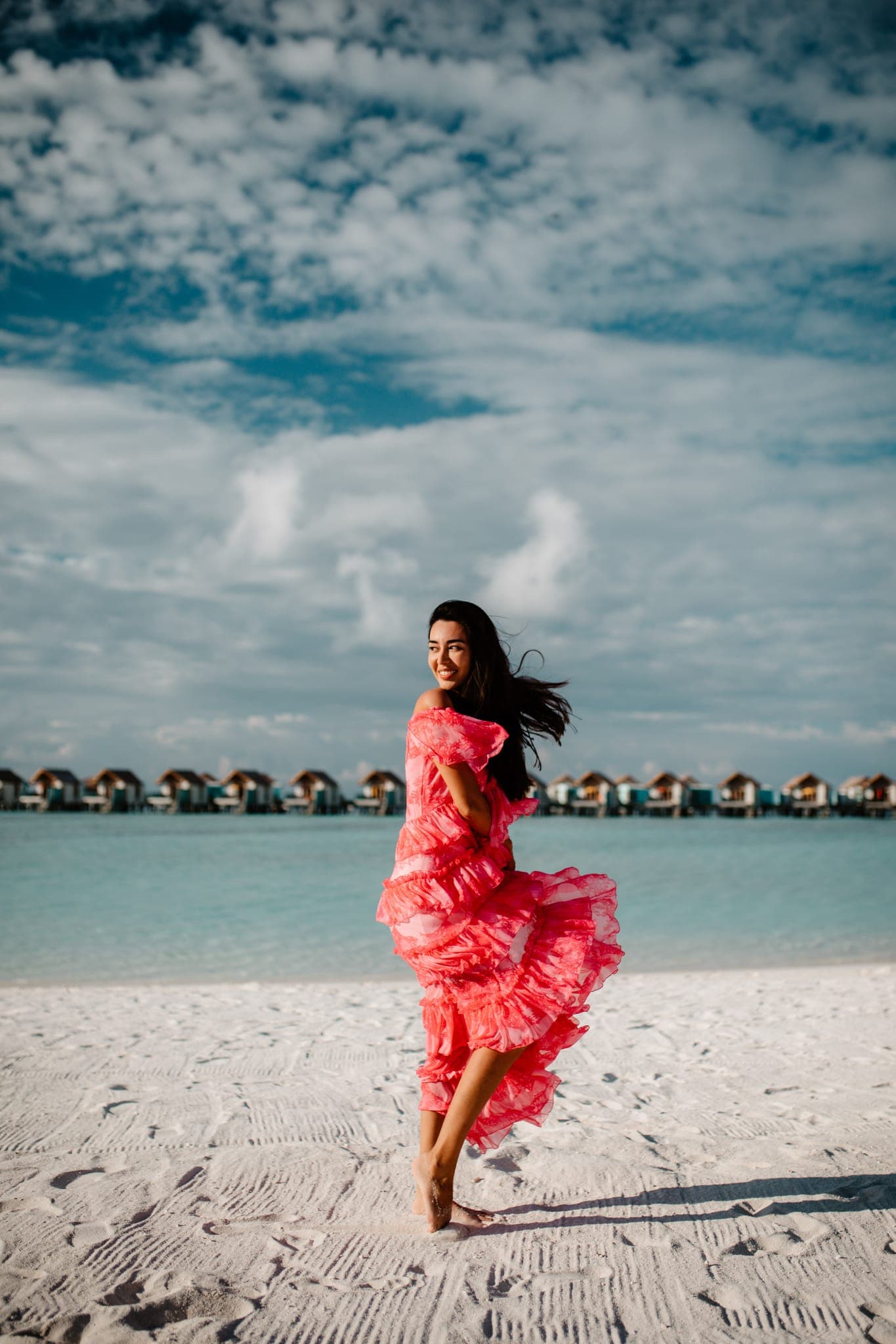 Couple playing on beach, man carrying woman piggyback