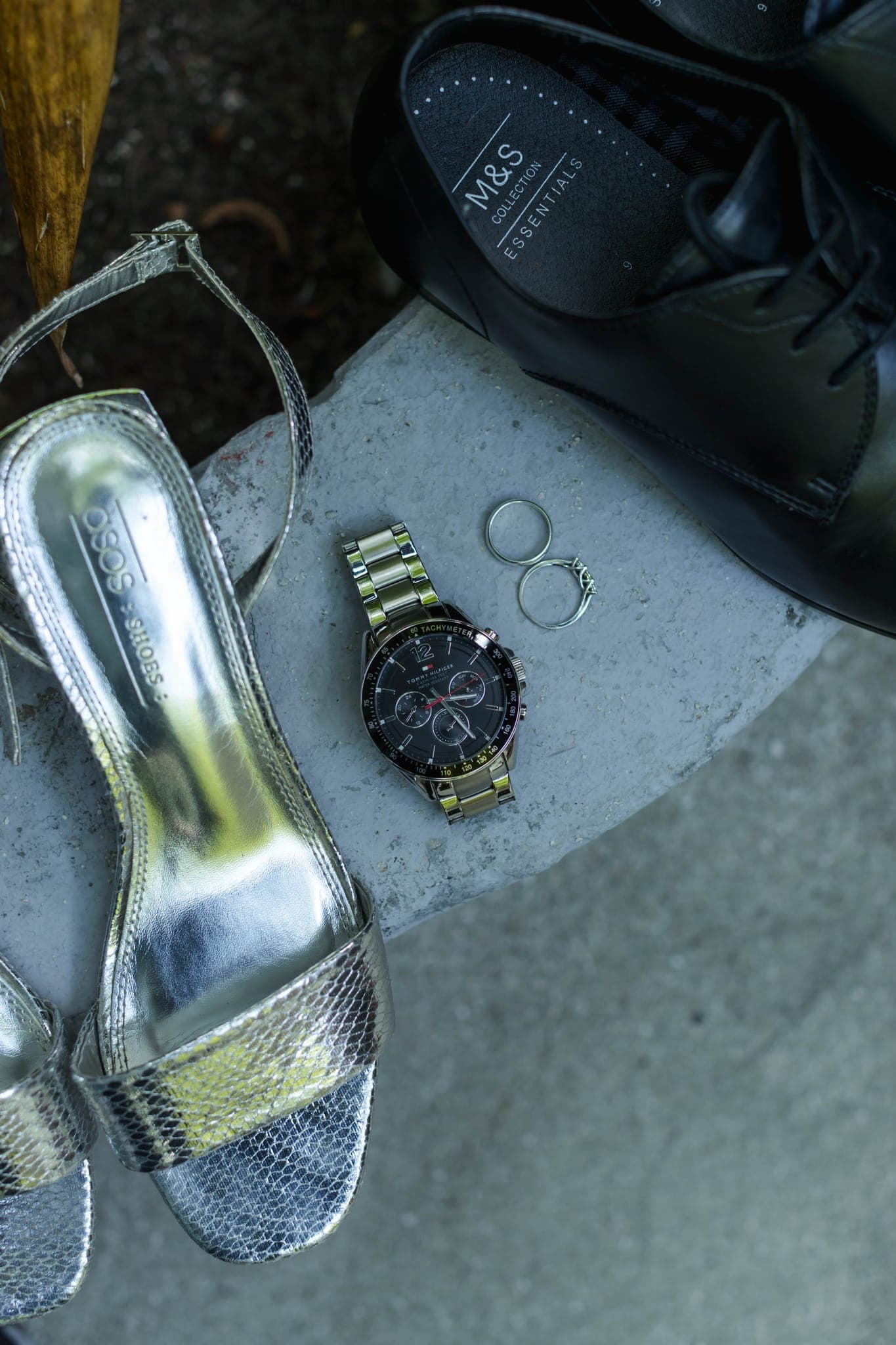Bridal heels, groom's shoes, watch and rings arranged flatlay